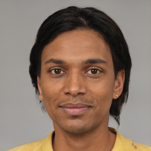 Joyful black adult male with short  black hair and brown eyes