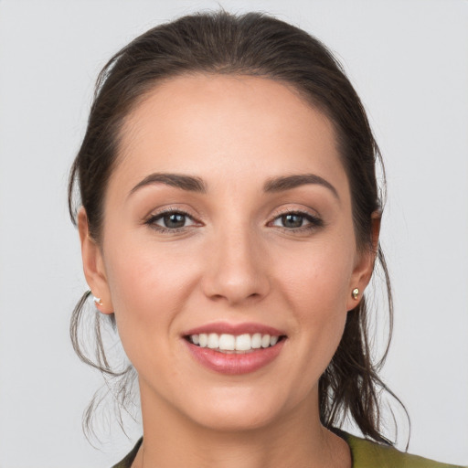 Joyful white young-adult female with medium  brown hair and brown eyes