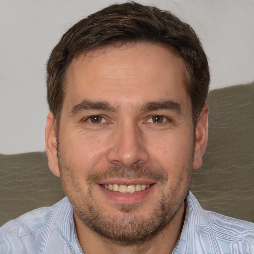 Joyful white adult male with short  brown hair and brown eyes