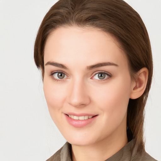 Joyful white young-adult female with medium  brown hair and grey eyes