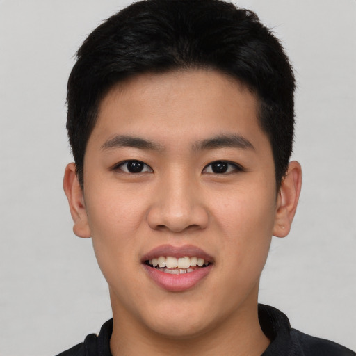 Joyful asian young-adult male with short  black hair and brown eyes