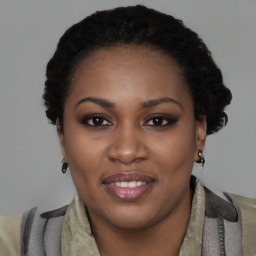 Joyful black young-adult female with short  black hair and brown eyes