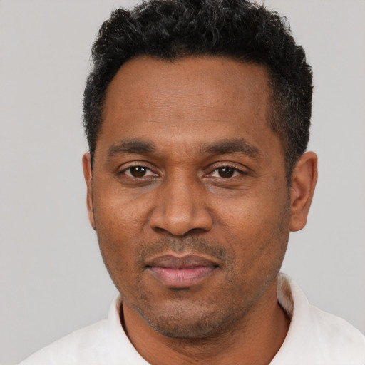 Neutral black adult male with short  black hair and brown eyes
