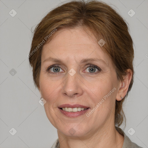 Joyful white adult female with medium  brown hair and grey eyes