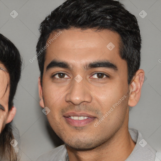 Joyful white young-adult male with short  black hair and brown eyes