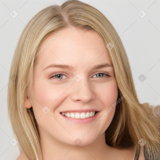 Joyful white young-adult female with long  blond hair and blue eyes