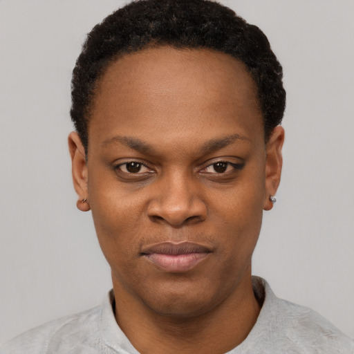 Joyful black young-adult female with short  black hair and brown eyes