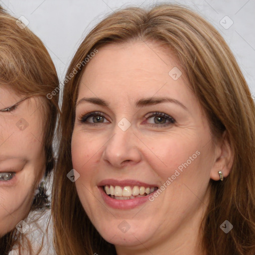 Joyful white adult female with medium  brown hair and brown eyes