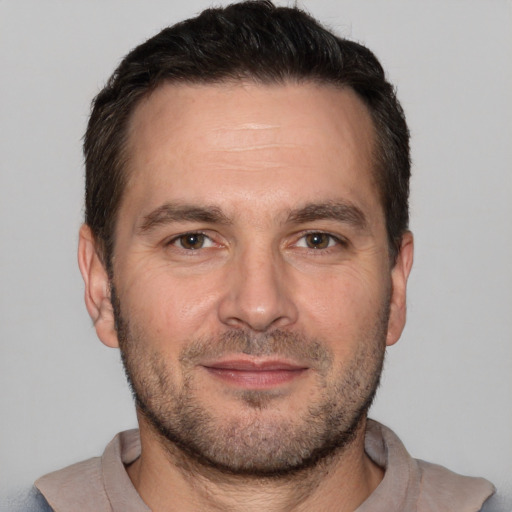 Joyful white adult male with short  brown hair and brown eyes