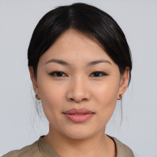 Joyful asian young-adult female with medium  black hair and brown eyes