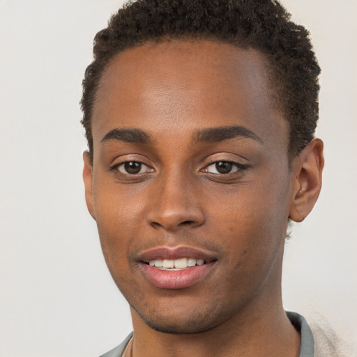 Joyful black young-adult male with short  brown hair and brown eyes