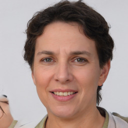 Joyful white adult female with short  brown hair and brown eyes