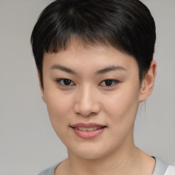 Joyful asian young-adult female with short  brown hair and brown eyes