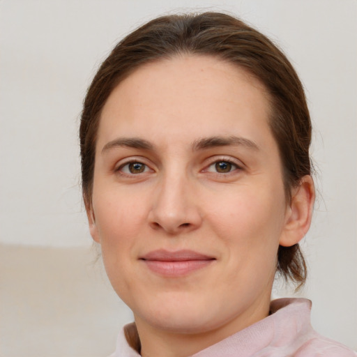 Joyful white young-adult female with medium  brown hair and green eyes