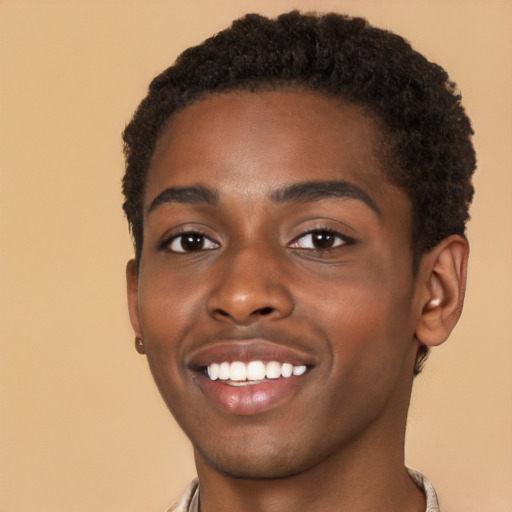 Joyful black young-adult male with short  brown hair and brown eyes