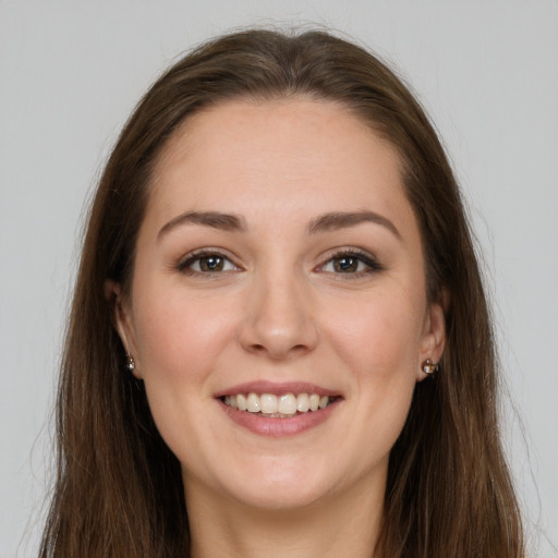 Joyful white young-adult female with long  brown hair and grey eyes