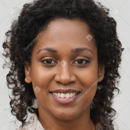 Joyful black young-adult female with long  brown hair and brown eyes