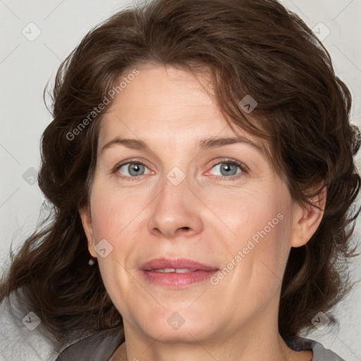 Joyful white adult female with medium  brown hair and blue eyes