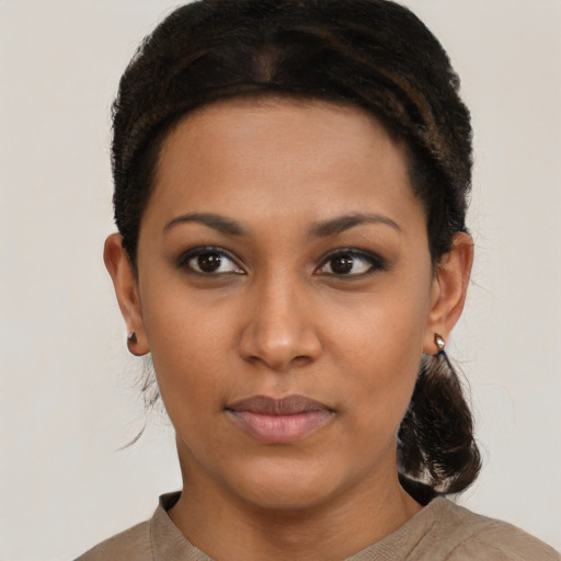 Joyful black young-adult female with short  brown hair and brown eyes