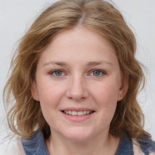 Joyful white young-adult female with medium  brown hair and blue eyes