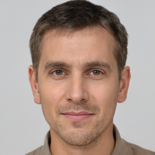 Joyful white adult male with short  brown hair and brown eyes