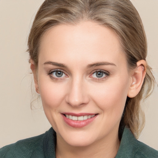 Joyful white young-adult female with medium  brown hair and grey eyes