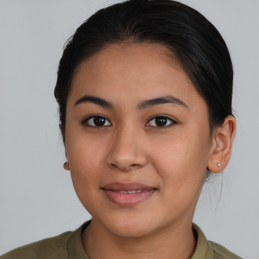 Joyful latino young-adult female with medium  brown hair and brown eyes