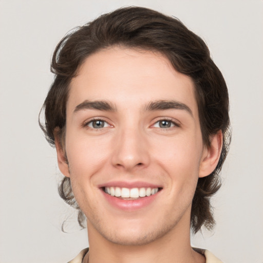 Joyful white young-adult male with medium  brown hair and brown eyes