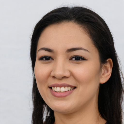 Joyful asian young-adult female with long  brown hair and brown eyes