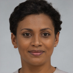 Joyful black young-adult female with short  brown hair and brown eyes