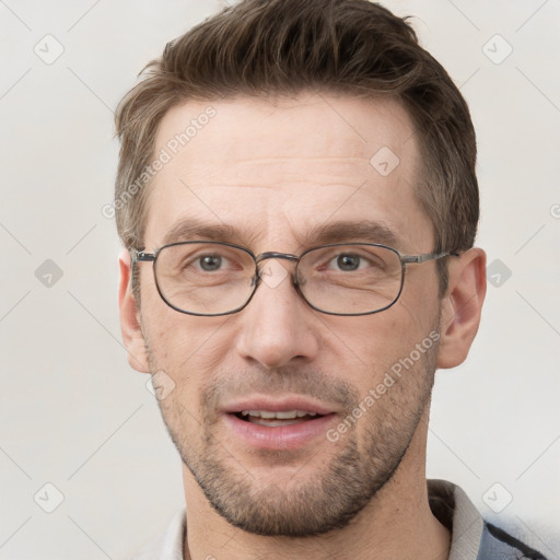 Joyful white adult male with short  brown hair and grey eyes