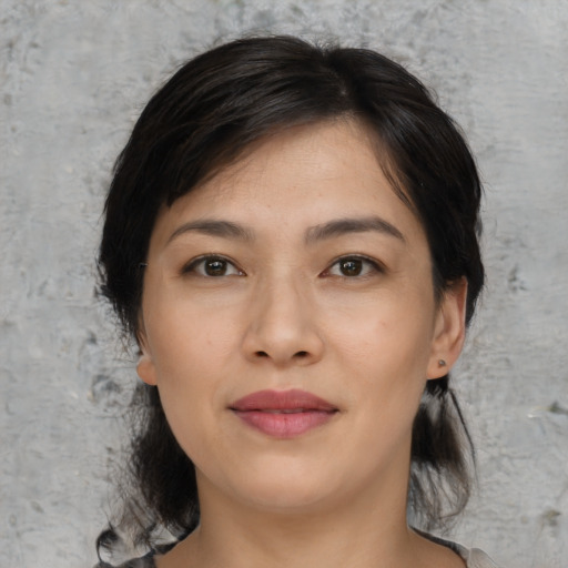 Joyful asian young-adult female with medium  black hair and brown eyes