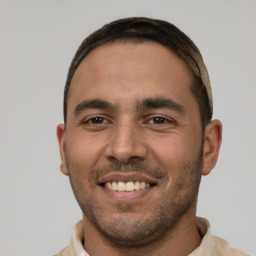 Joyful white young-adult male with short  black hair and brown eyes