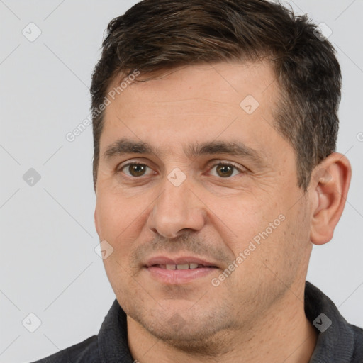 Joyful white adult male with short  brown hair and brown eyes