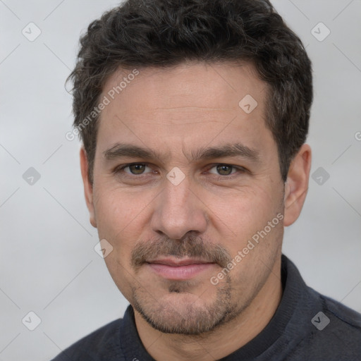 Joyful white adult male with short  brown hair and brown eyes