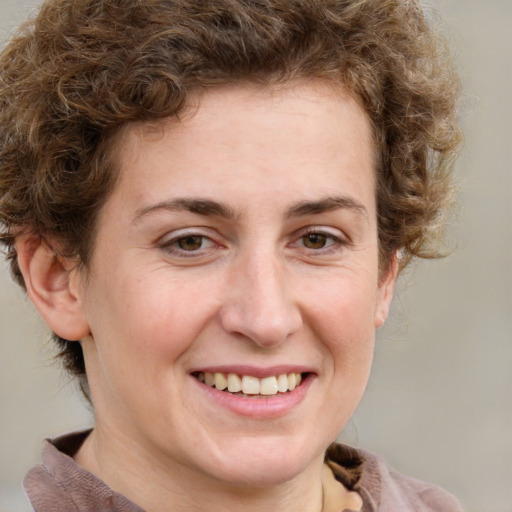 Joyful white adult female with short  brown hair and grey eyes