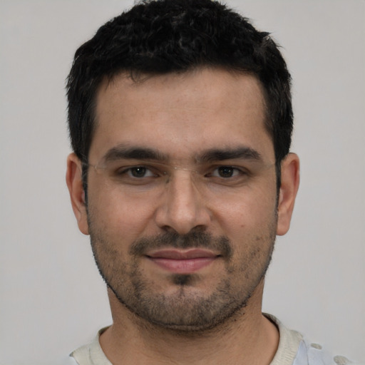 Joyful white young-adult male with short  black hair and brown eyes