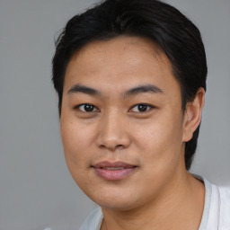 Joyful asian young-adult male with short  black hair and brown eyes