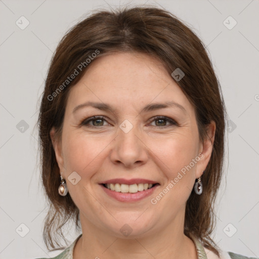 Joyful white adult female with medium  brown hair and grey eyes