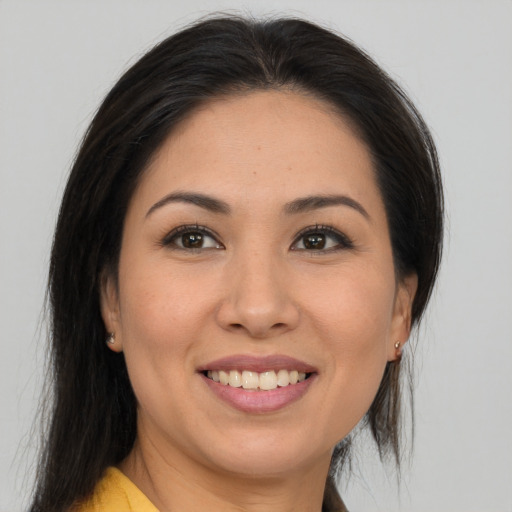 Joyful asian young-adult female with medium  brown hair and brown eyes