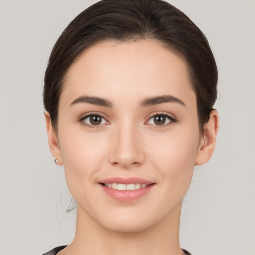 Joyful white young-adult female with medium  brown hair and brown eyes