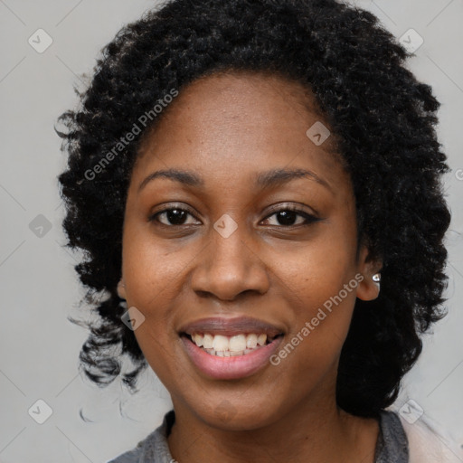 Joyful black young-adult female with long  black hair and brown eyes