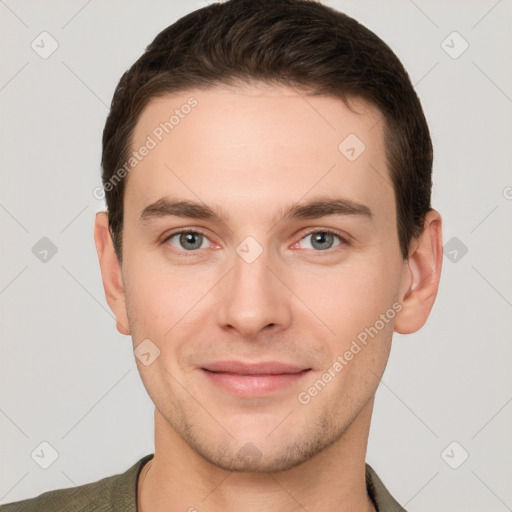 Joyful white young-adult male with short  brown hair and grey eyes