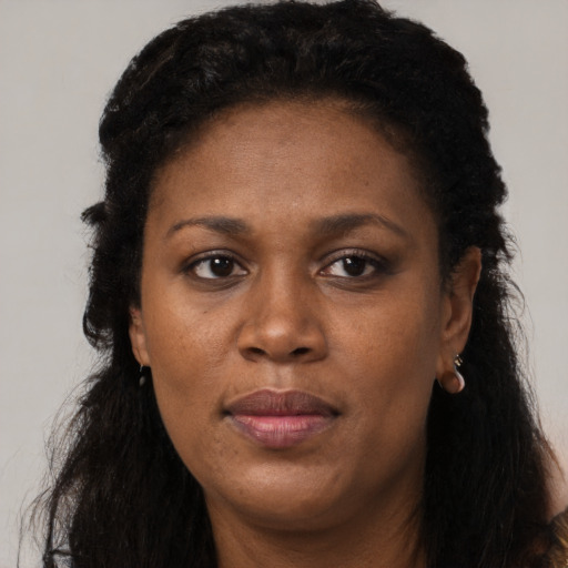 Joyful black adult female with short  black hair and brown eyes