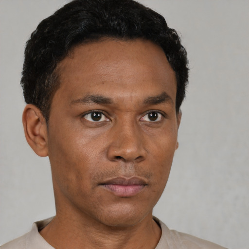 Neutral latino adult male with short  black hair and brown eyes