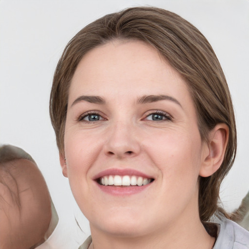 Joyful white young-adult female with medium  brown hair and grey eyes