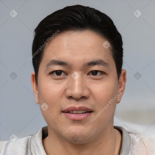 Joyful asian young-adult male with short  black hair and brown eyes