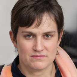 Joyful white adult female with medium  brown hair and grey eyes