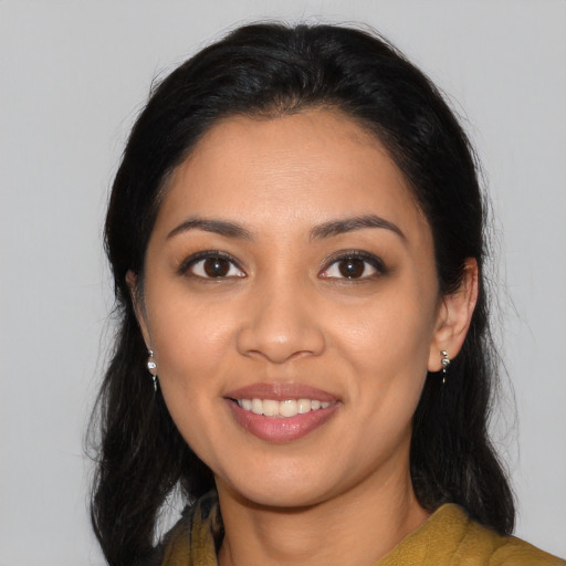 Joyful latino young-adult female with medium  black hair and brown eyes