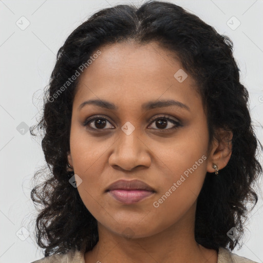 Joyful black young-adult female with long  brown hair and brown eyes